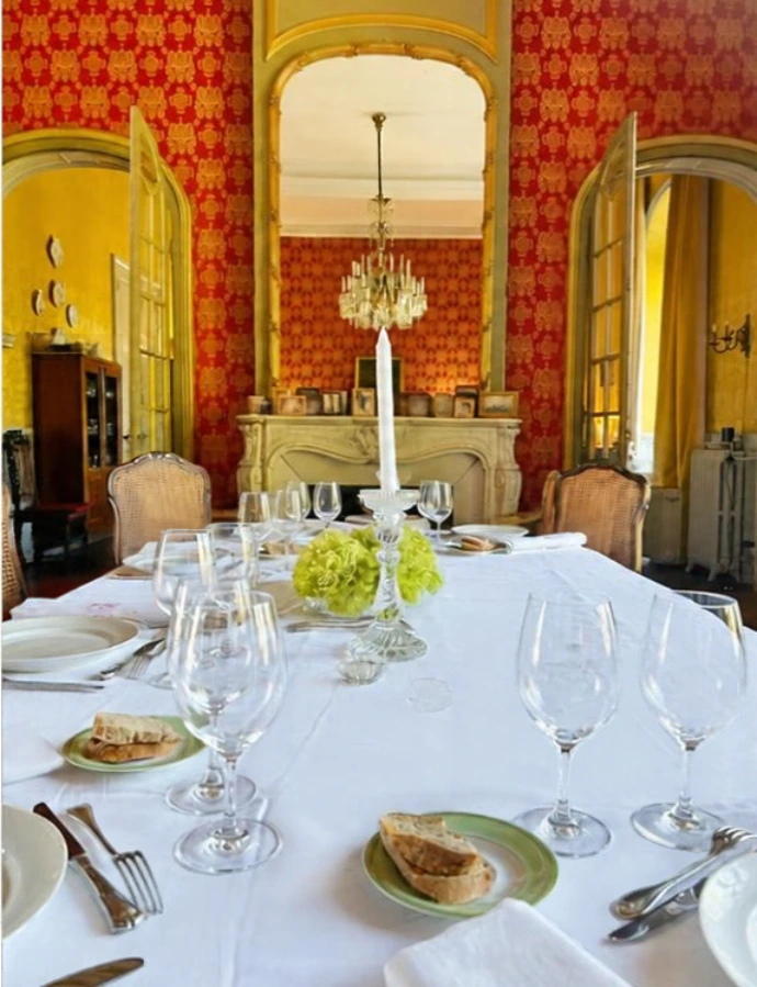 table dressée à l'intérieur sous un lustre en cristal majestueux avec des tentures rouge foncées